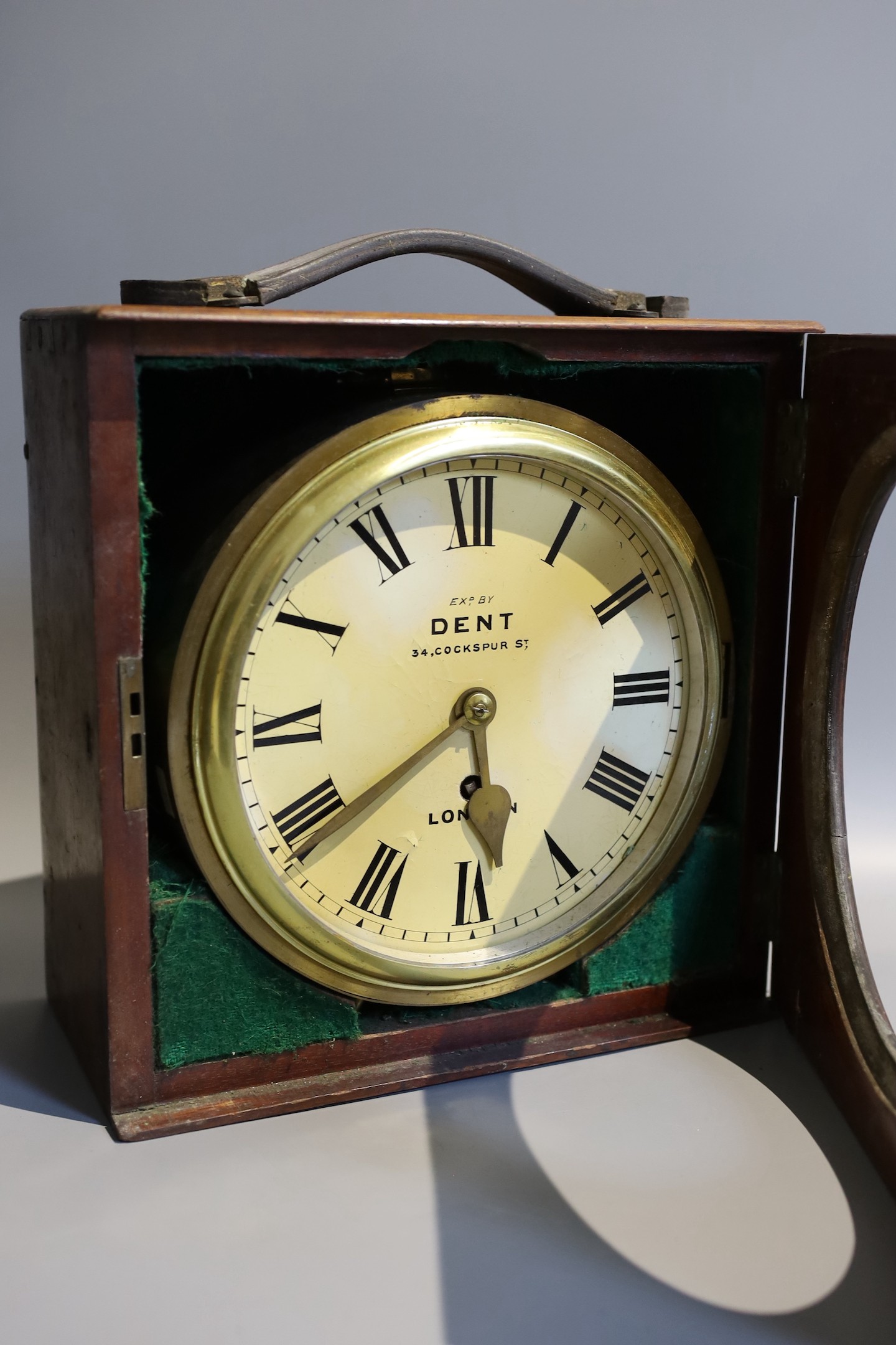 A 19th century mahogany cased circular lacquered brass travelling timepiece marked Dent London, case width 28 cms.